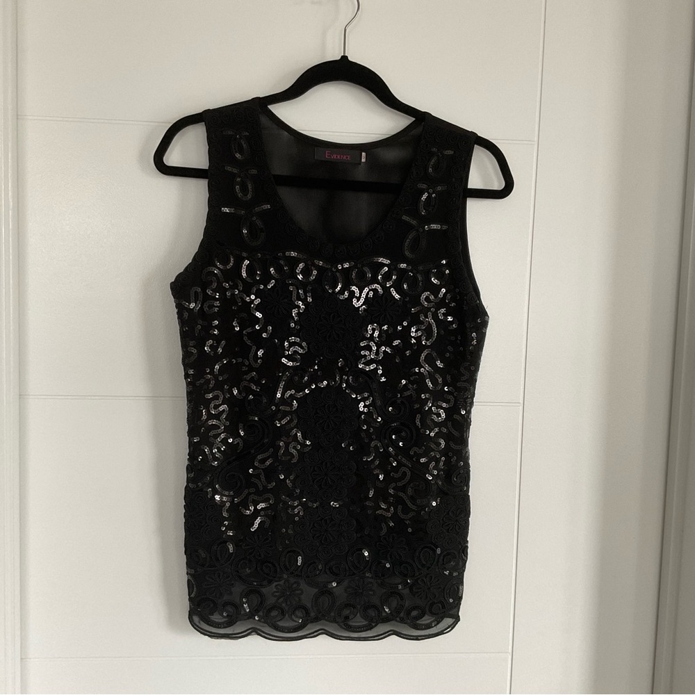 Black seckence sleeveless blac top. Very elegant. Whole back net see threw.